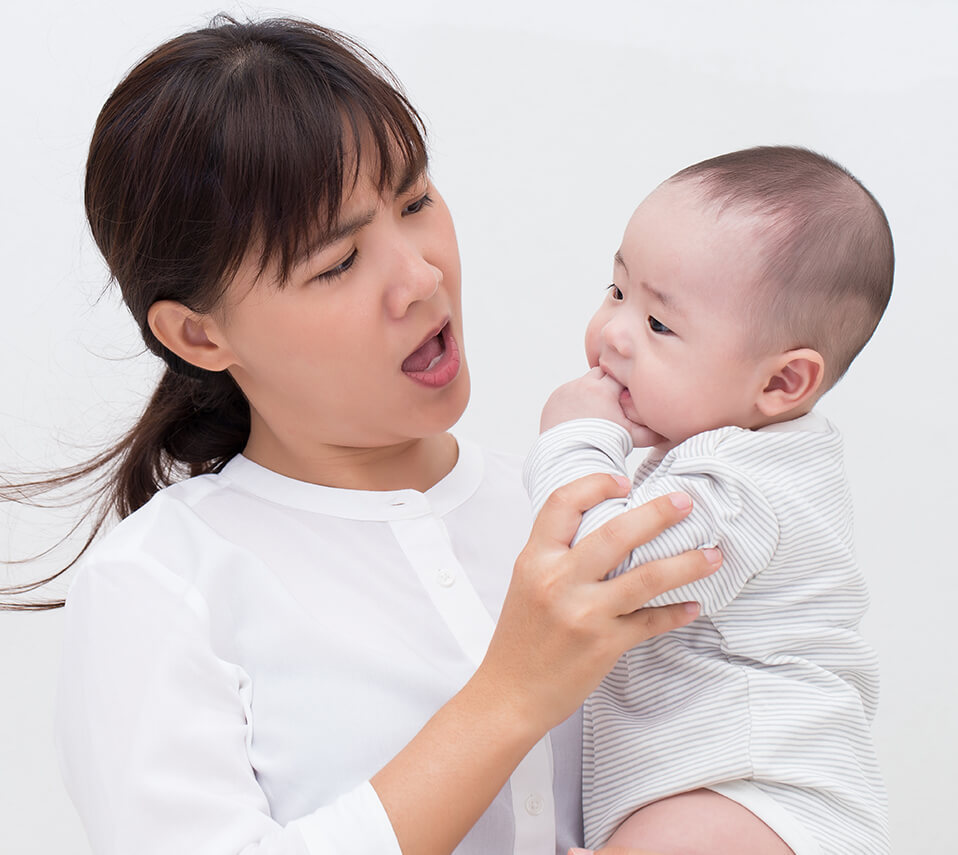 angry mom holding her baby