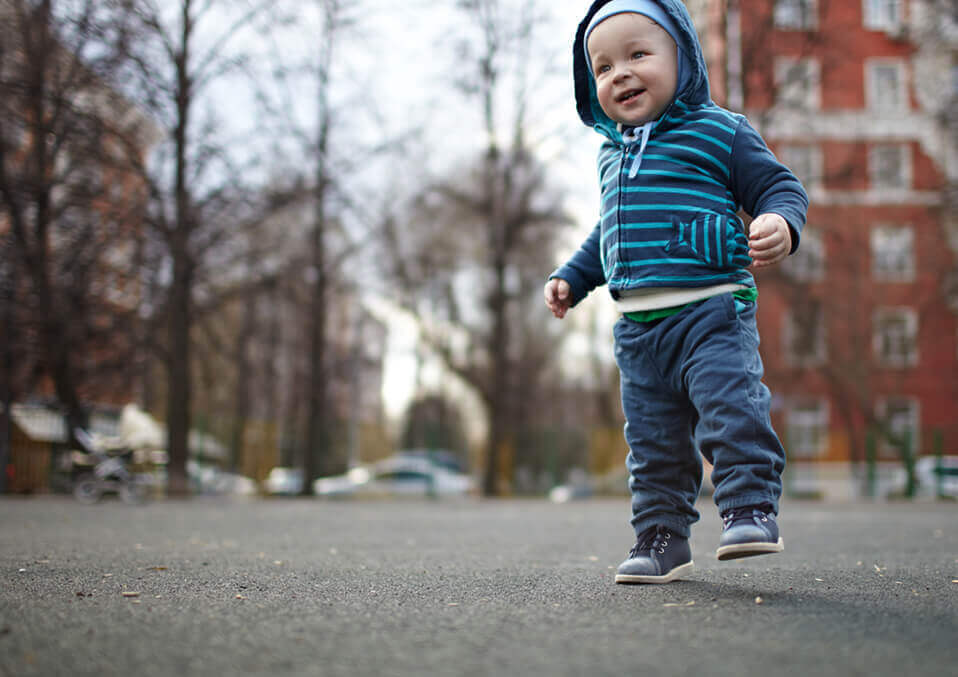 baby wearing shoes and learning how to walk with them