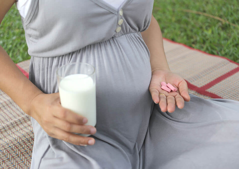 pills and a pregnant woman